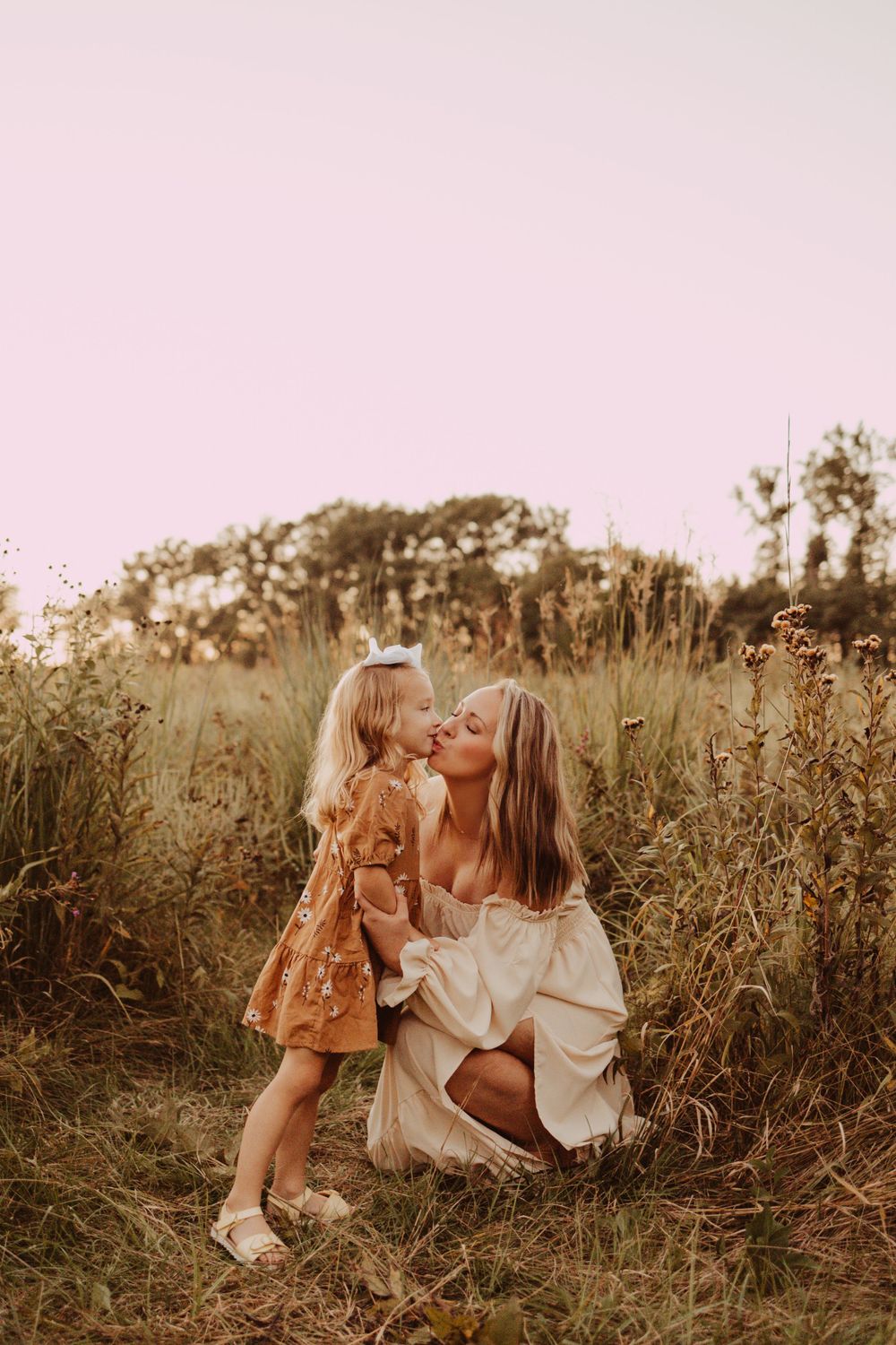 kisses for mom in the field during family photography session