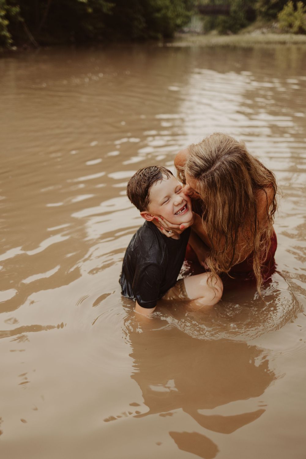 mom and son play in water for creek family photography session