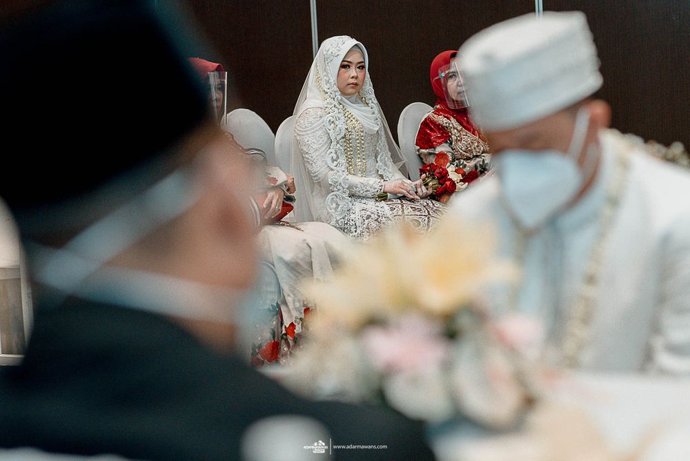 Traditional wedding ceremony with attendees in formal cultural attire.