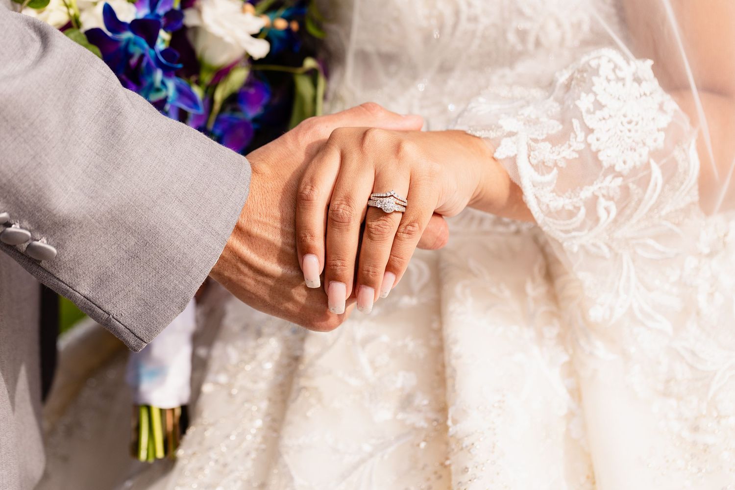 hands holding with wedding ring and engagement ring