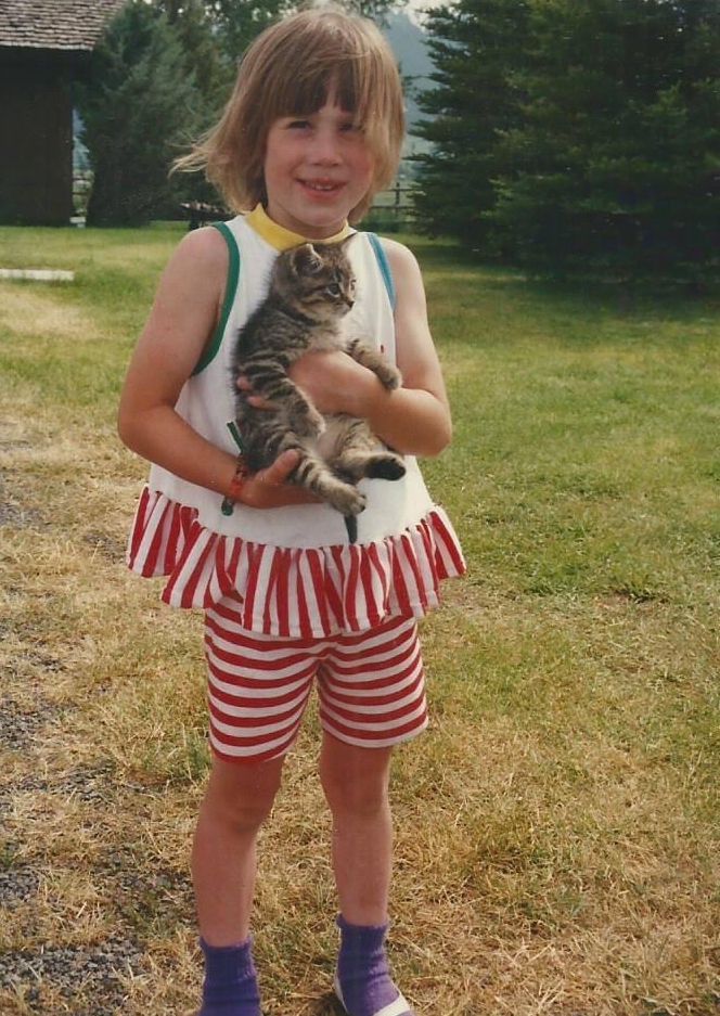 Little girl holding a kitten.