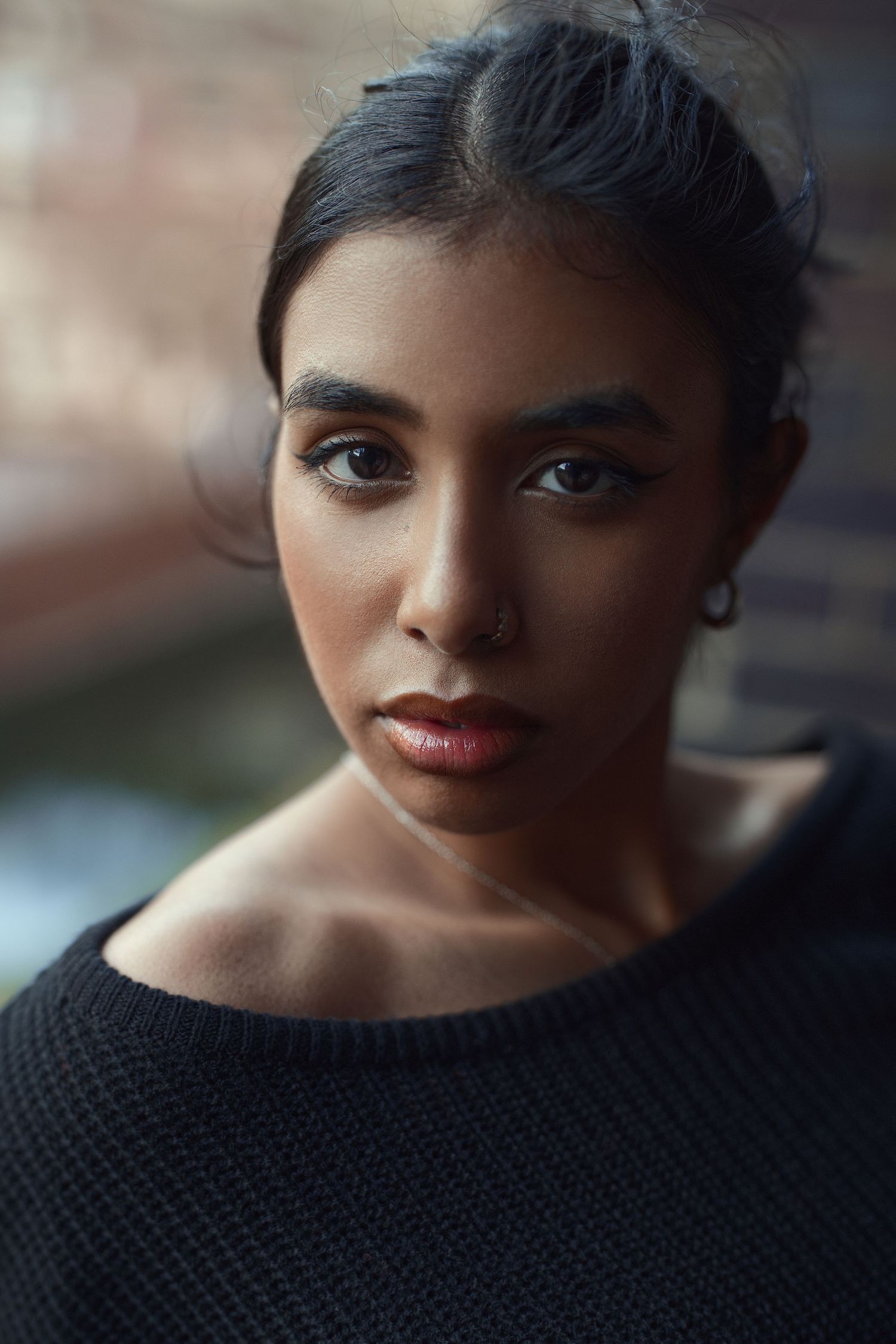 Close-up beauty portrait with soft lighting and neutral tones.