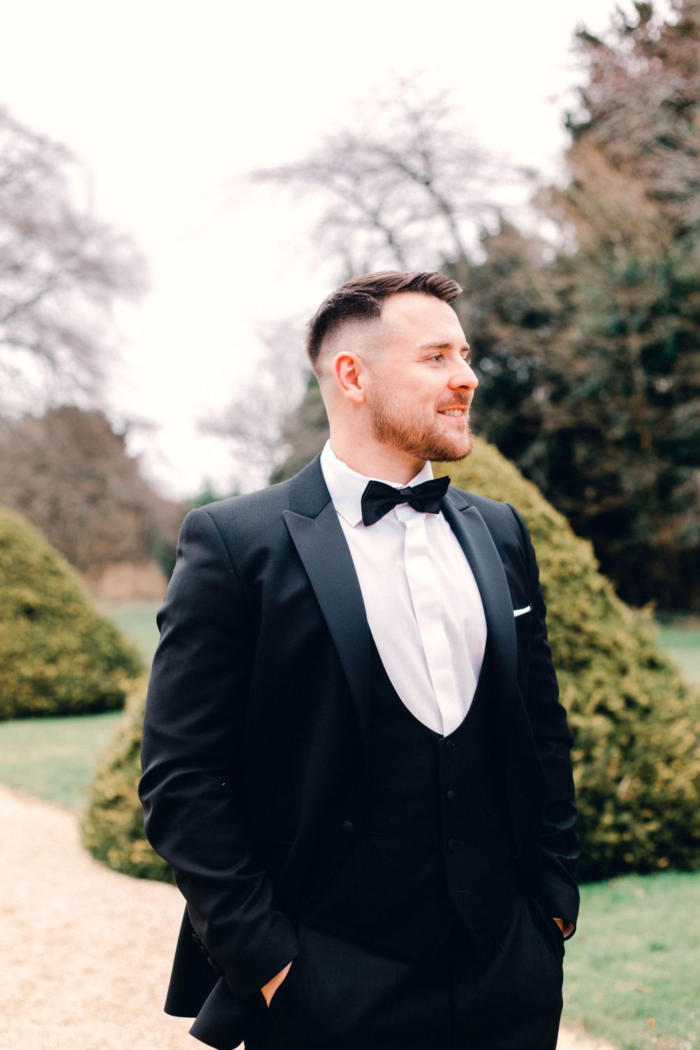 Classic elegant groom portrait at the Italian Gardens at Manor by the lake Wedding photographer