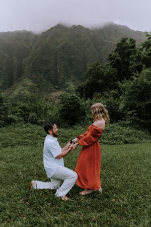 A marriage proposal scene captured in sequence against dramatic Hawaiian mountain landscape.