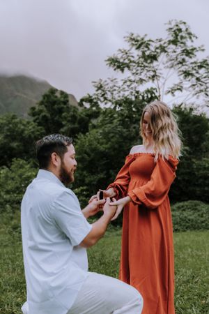 A heartfelt marriage proposal takes place in a verdant mountain valley.