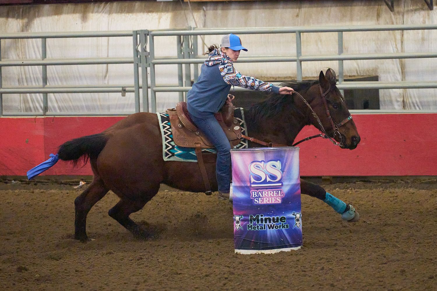 Barrel racer riding around the barrel.