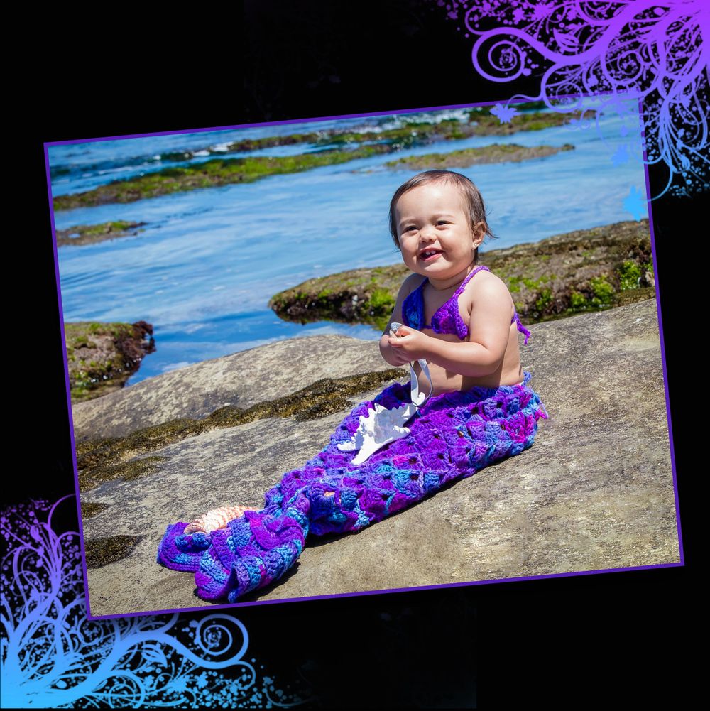 Coastal portrait with decorative blue frame showing purple mermaid tail costume.
