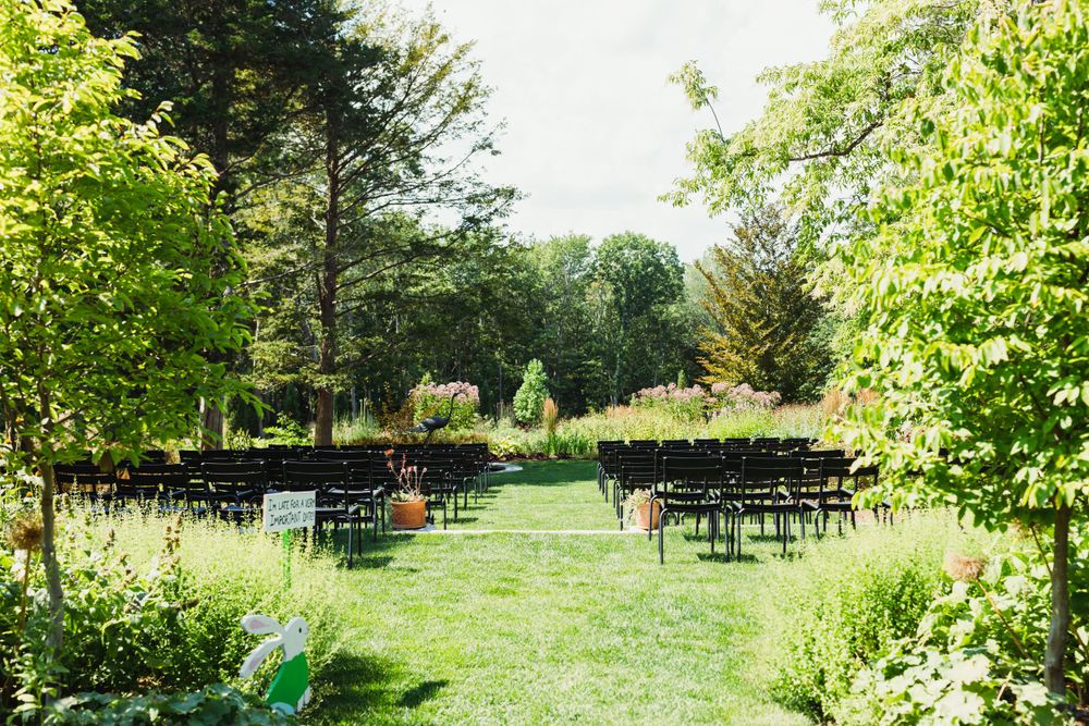 Beautiful outdoor garden wedding venue with lush green landscaping and natural pathways.