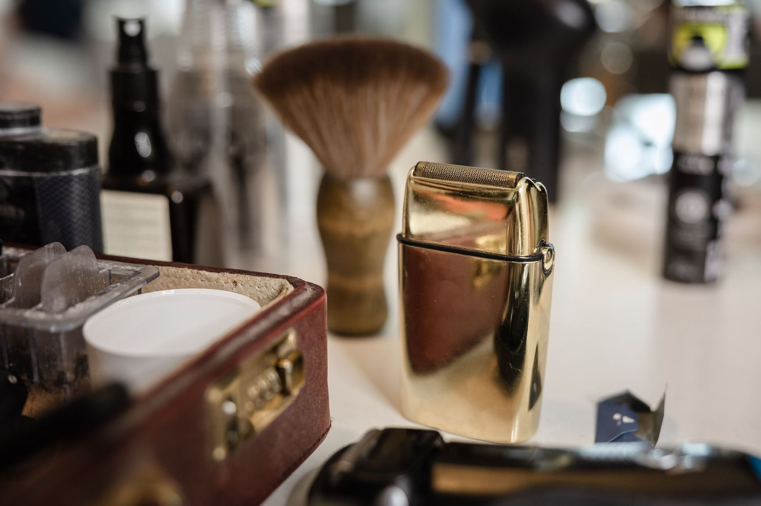 Vintage barbershop tools and grooming supplies arranged on wooden surface.