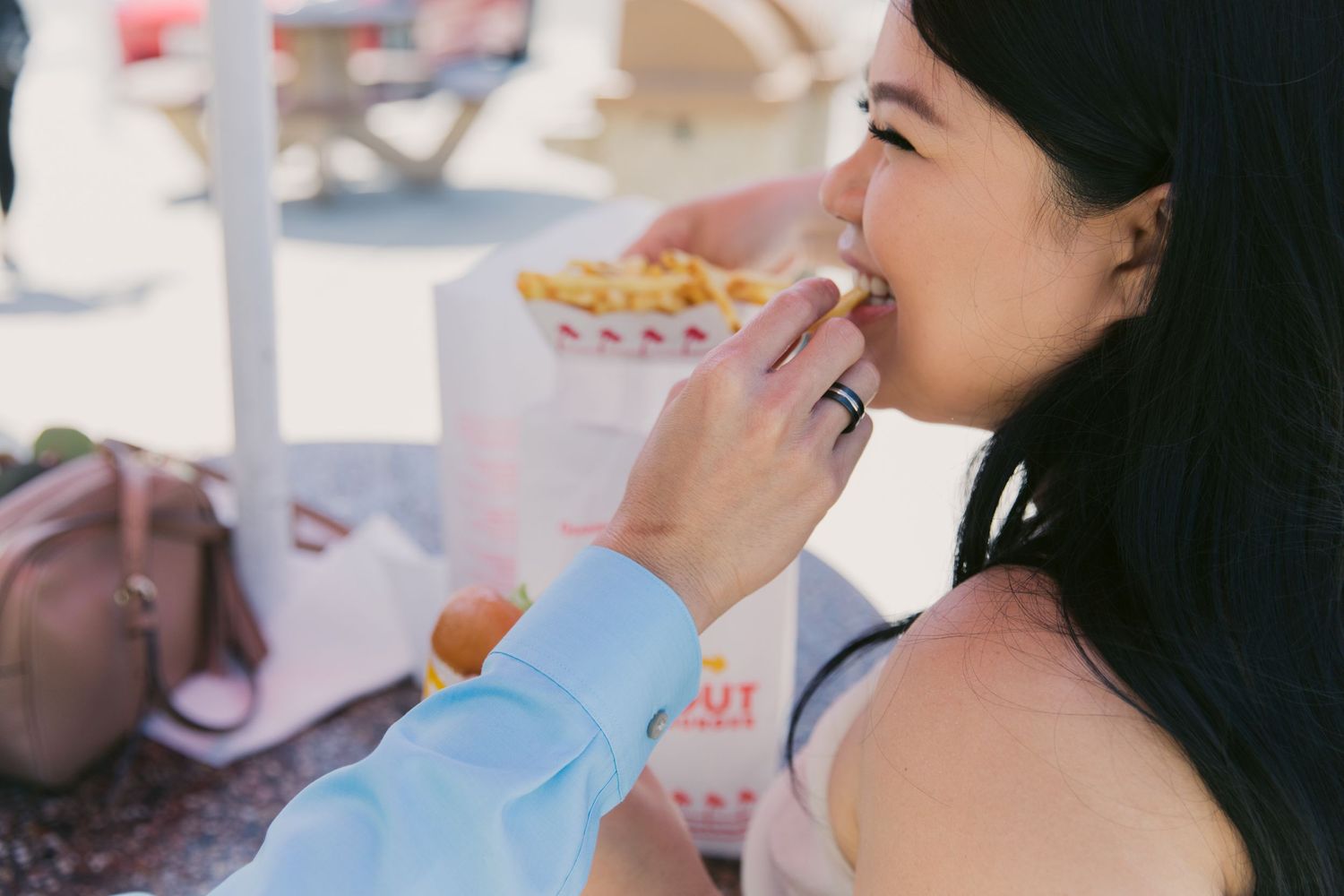 Close-up shot of someone drinking from a straw at a fast food restaurant.
