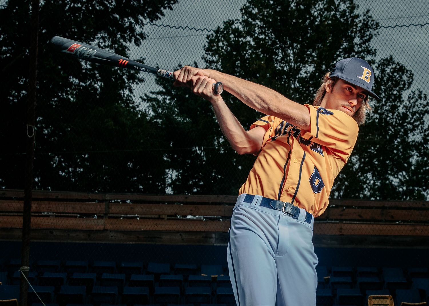 Photograph of Senior 2024, Bryce Downey, swinging the bat at home plate.