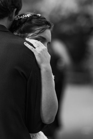 Intimate black and white moment of embracing couple.