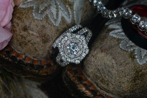 Close-up of an intricate vintage-style diamond engagement ring with halo design.