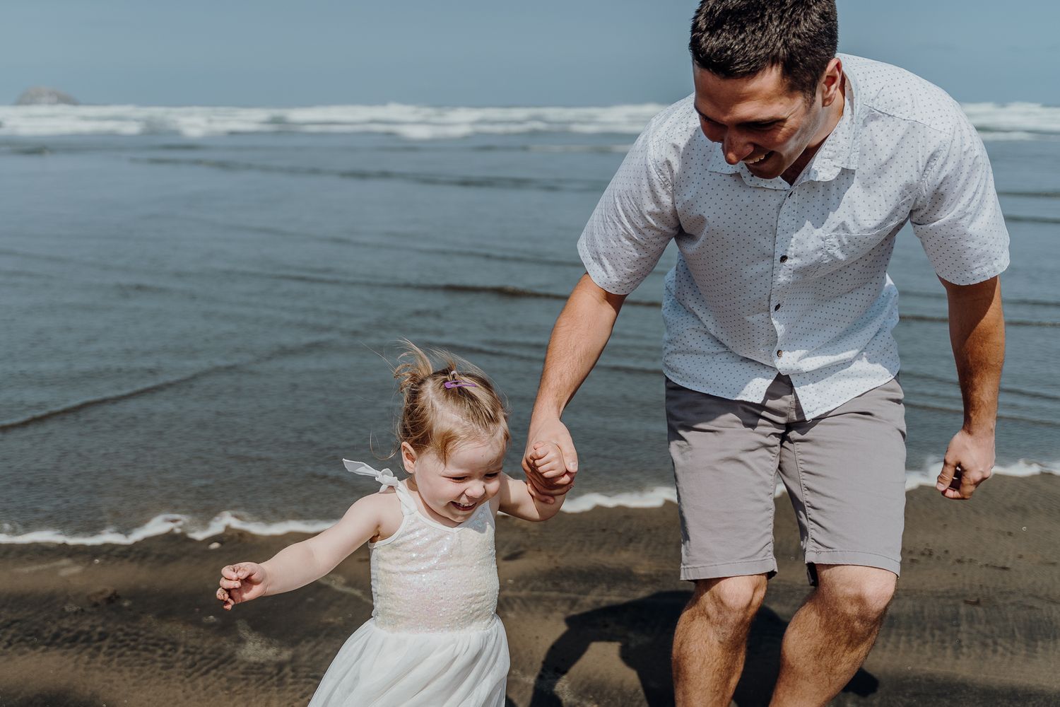 Running from the waves at Muriwai Beach with your dad is so so much fun!