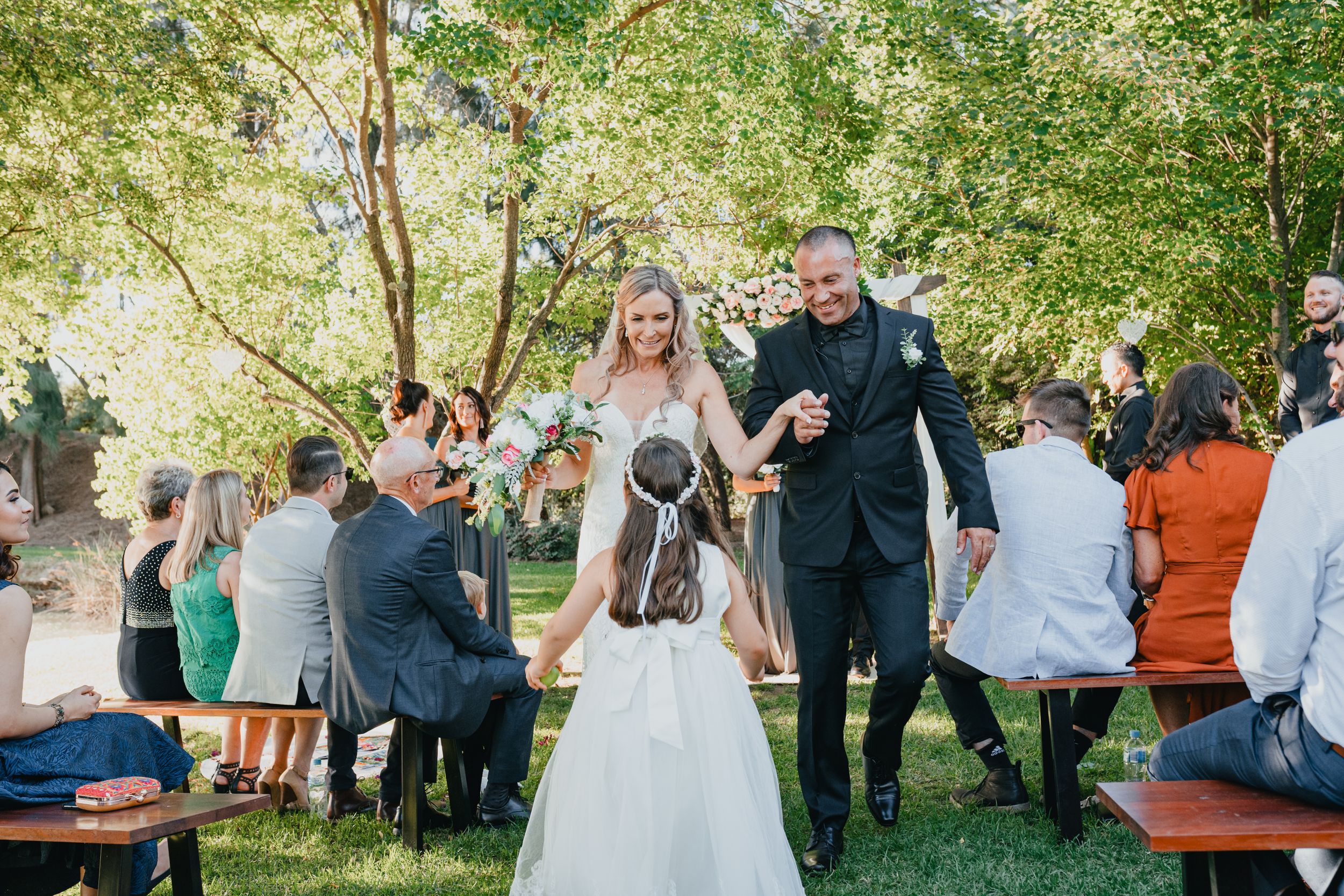 bride and groom walking down the aisle outdoor wedding