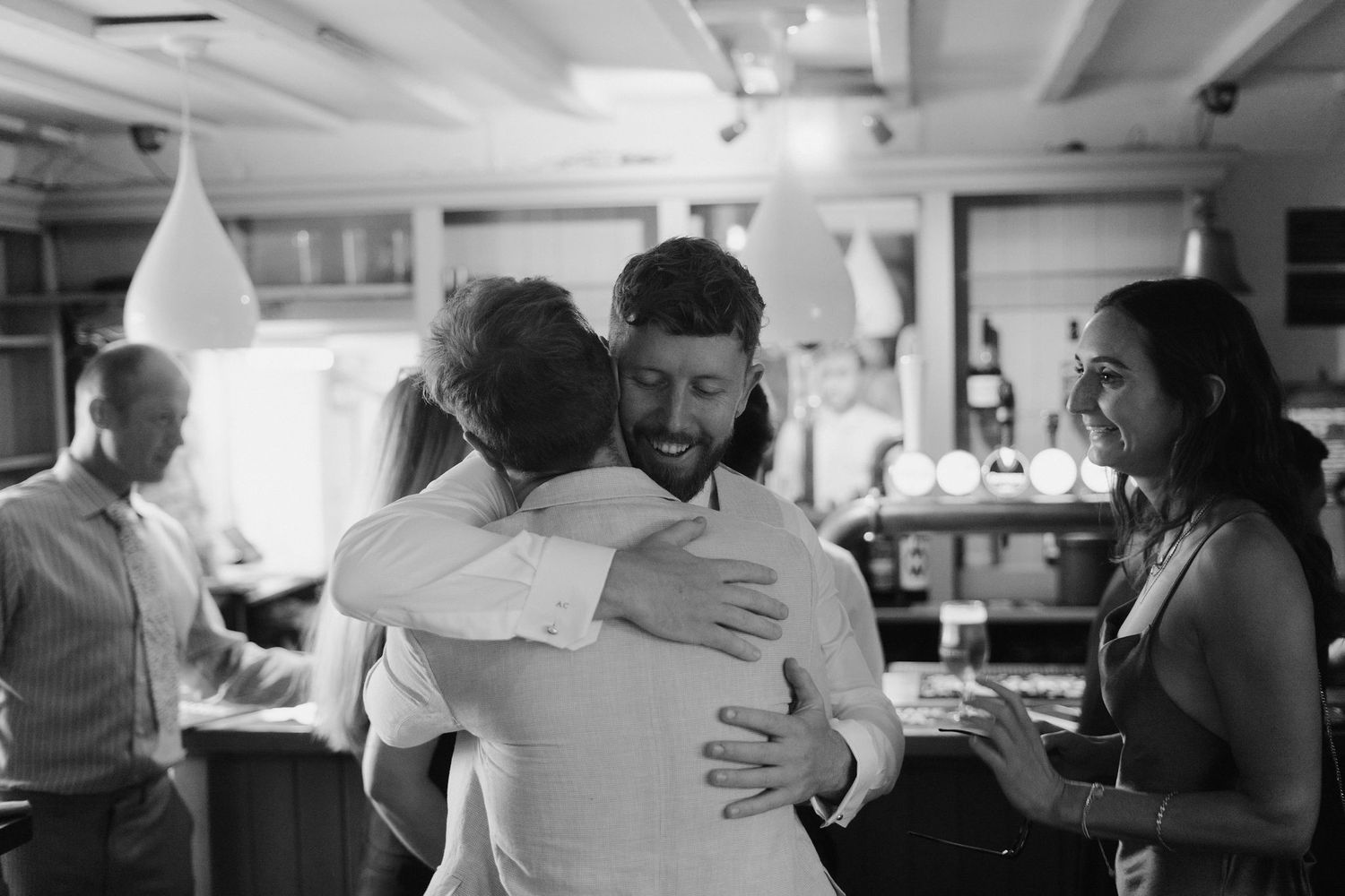 groom hugging groomsmen before his wedding ceremony in Oxfordshire