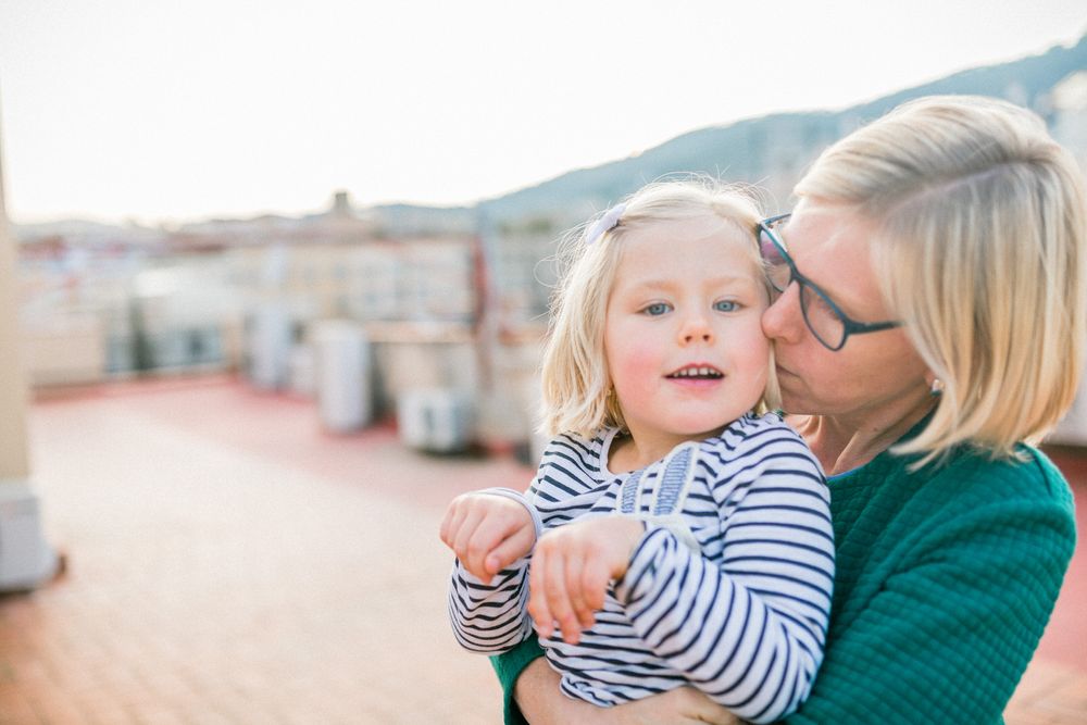 Tender moment captured on urban rooftop during golden hour.