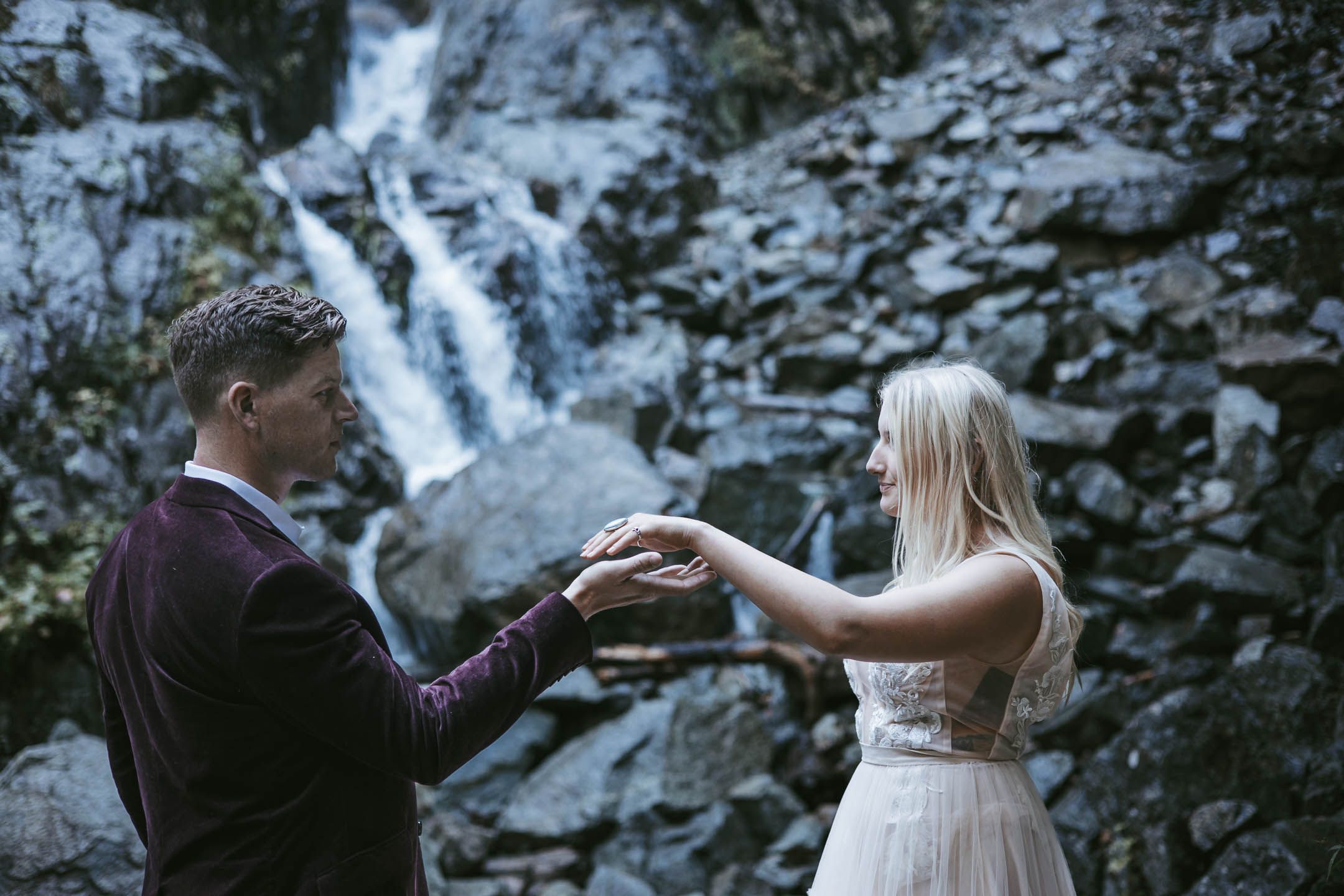 Intimate wedding photo of bride and groom close to a waterfall in New York State