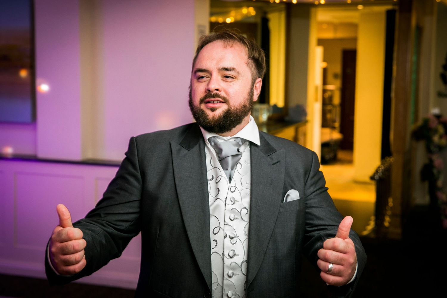 A joyful moment during a wedding celebration in an elegantly lit venue.