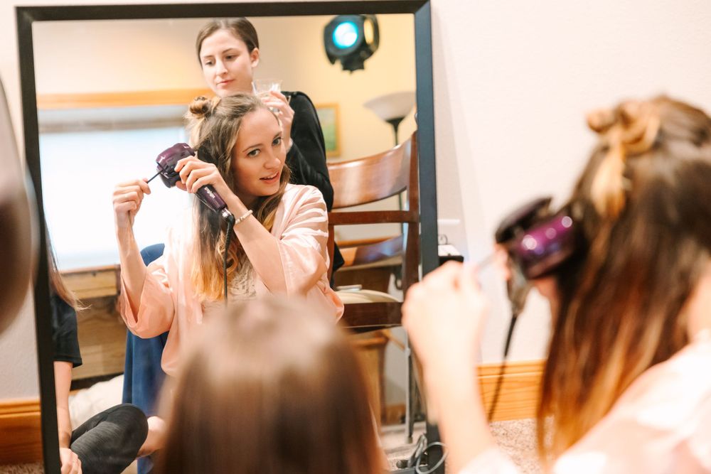 Wedding day preparation scene in a salon with styling in progress.