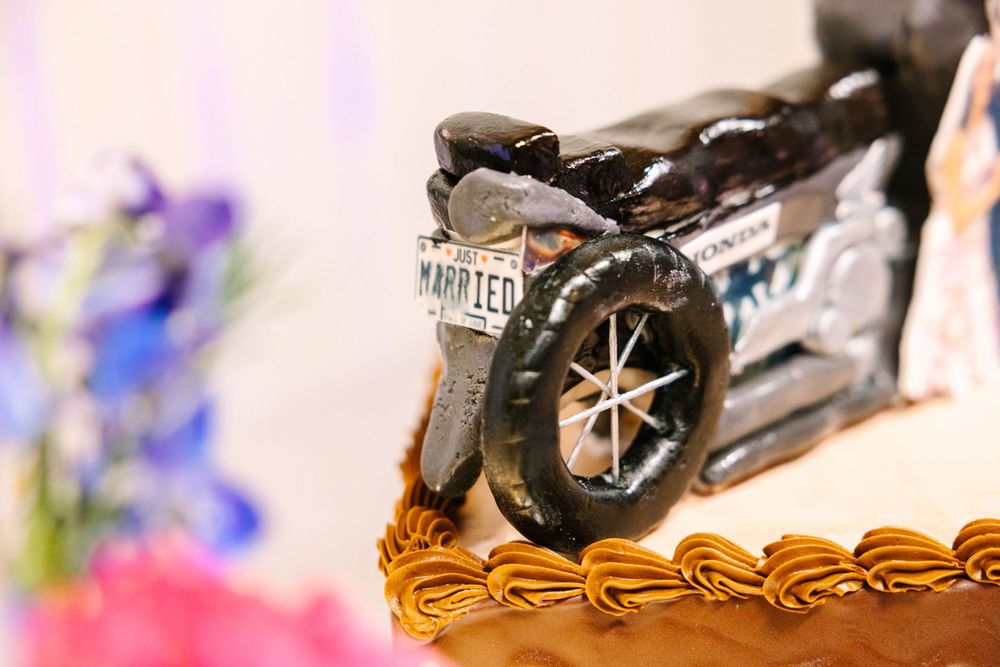 Close-up detail of motorcycle decoration on chocolate wedding cake.