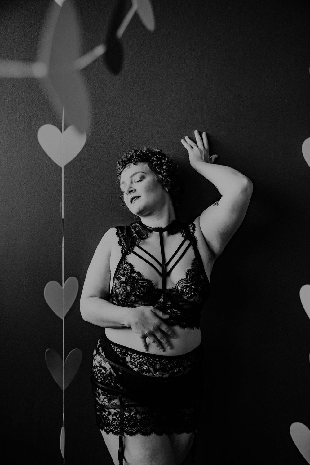 Artistic black and white boudoir photo series arranged as a creative collage with studio lighting and shadows.