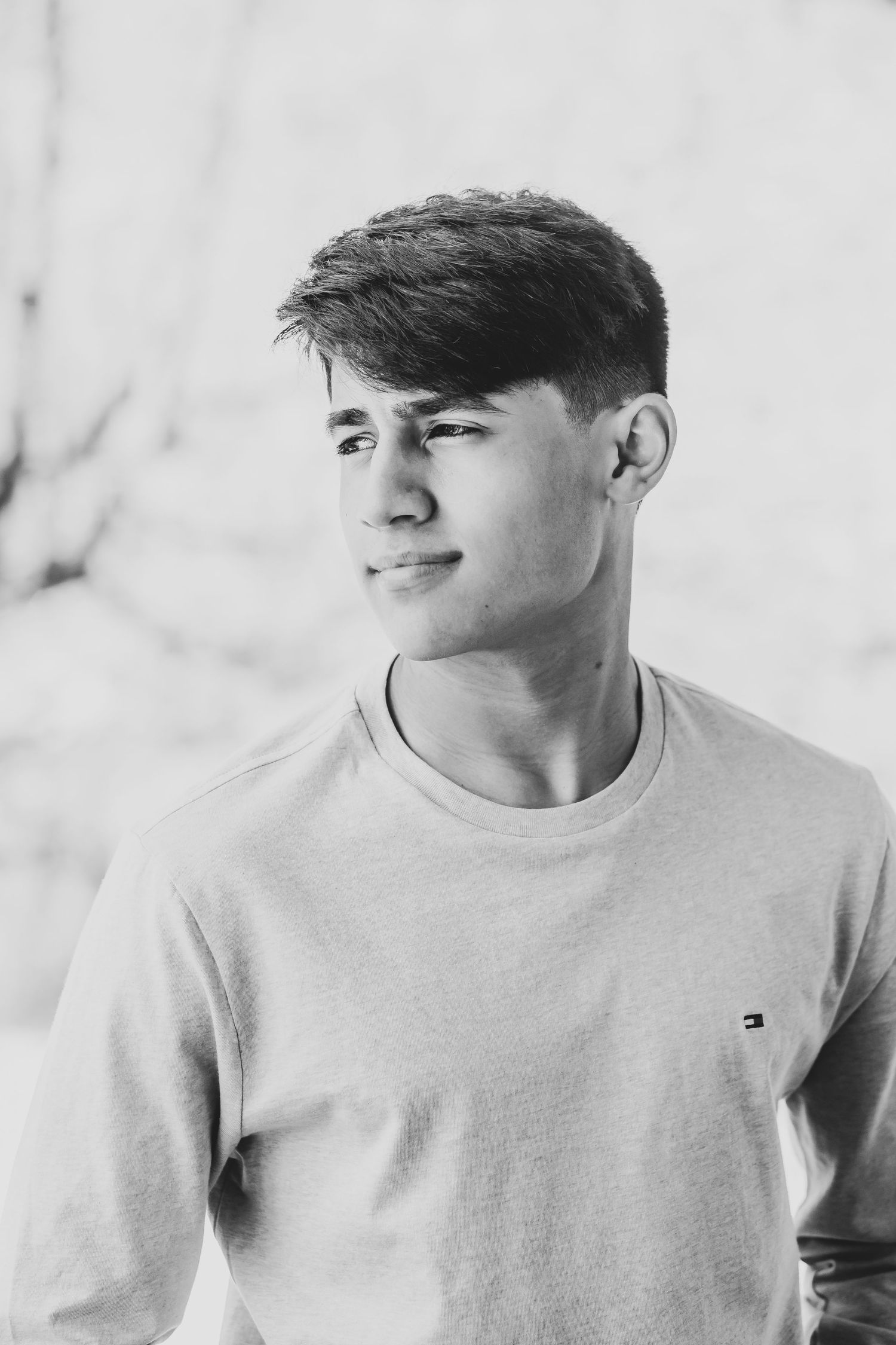 Black and white portrait of person in light colored Tommy Hilfiger shirt.