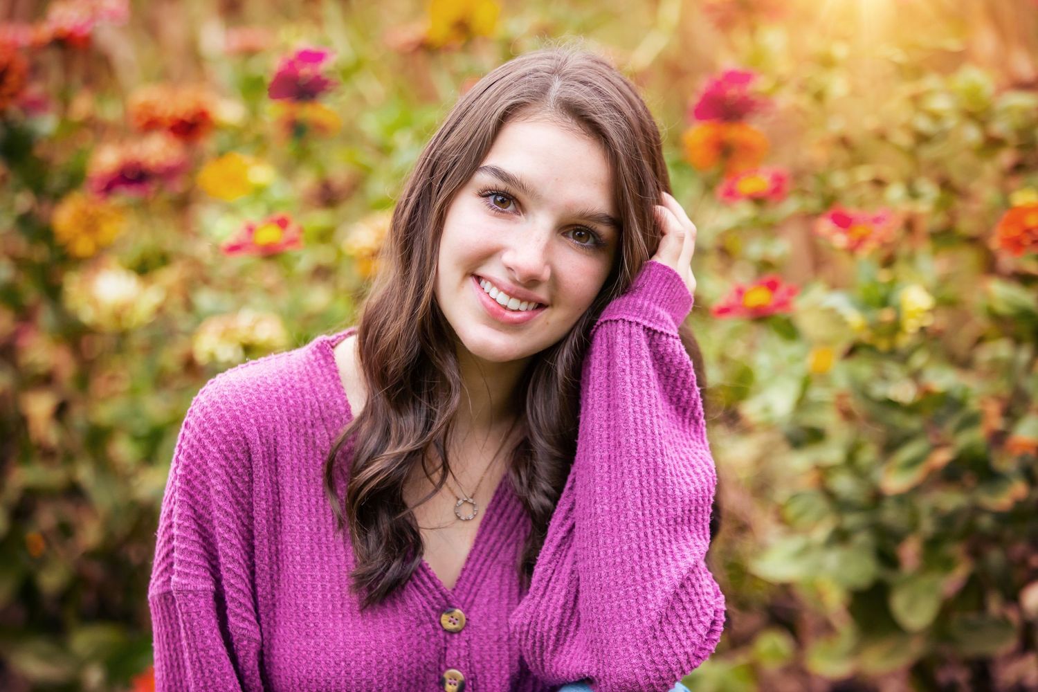 Portrait in pink sweater against colorful autumn garden background.