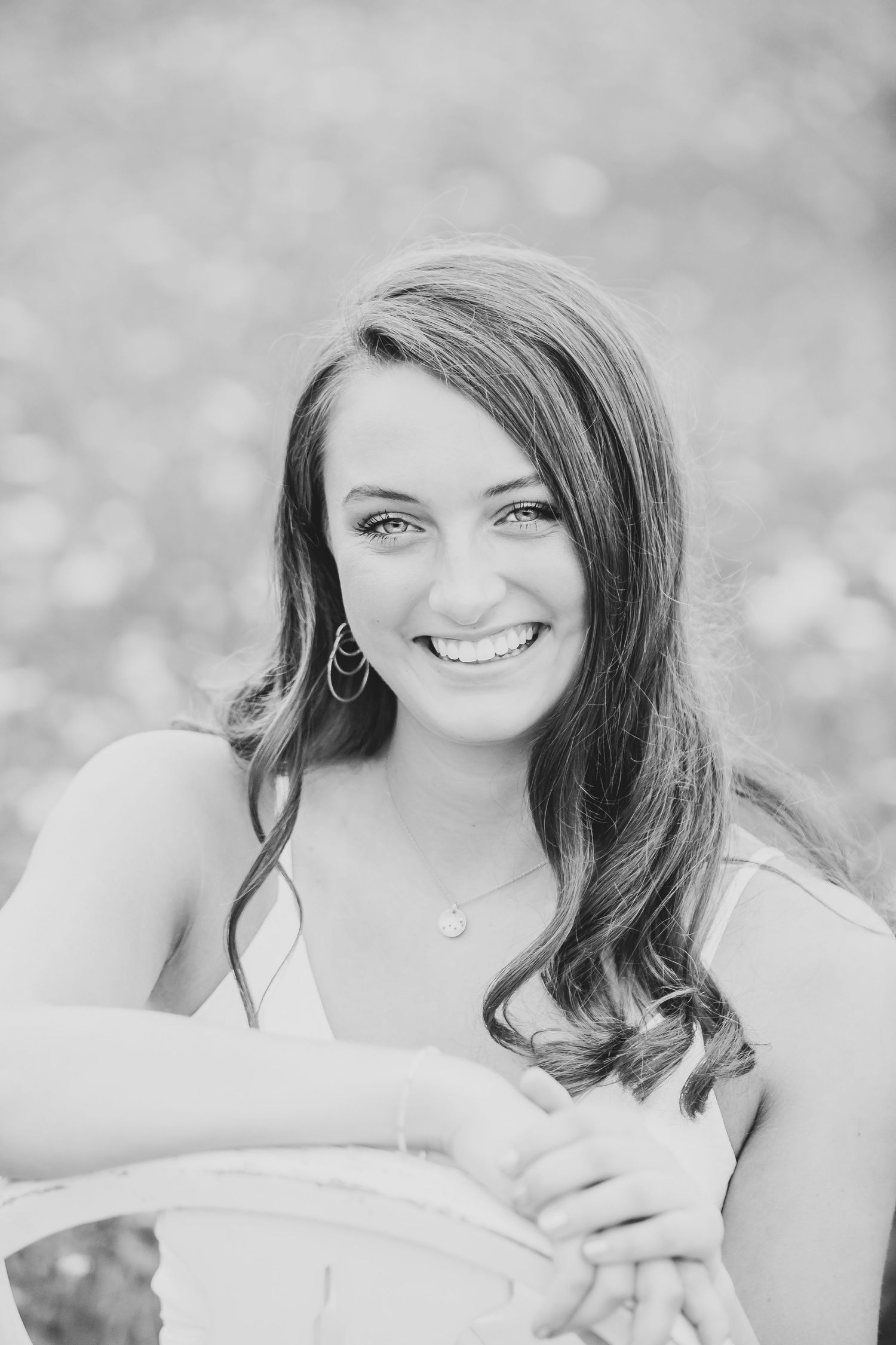 A black and white portrait showcasing soft lighting and elegant styling.
