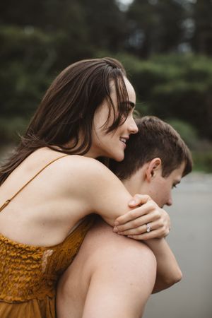 Close-up of a joyful moment shared between two people during a beach photoshoot.