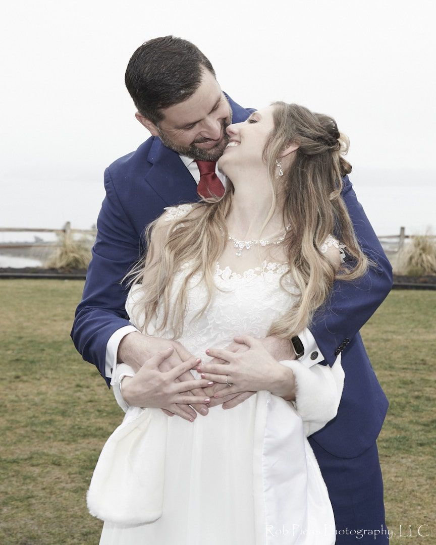 Bride and Groom attempting first kiss  but giggling, at Tacoma Environmental Services Building