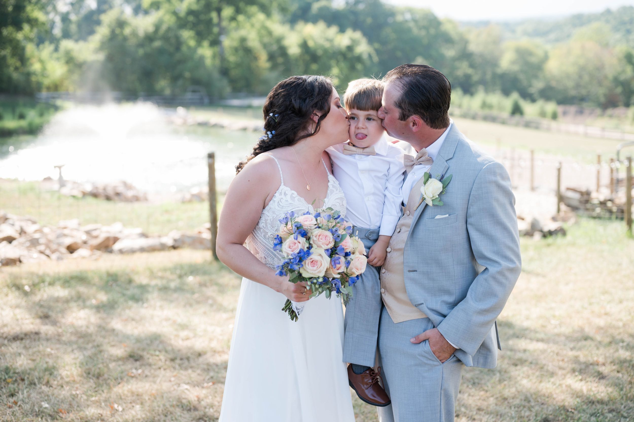 Romantic outdoor wedding photography session in a sunlit meadow.