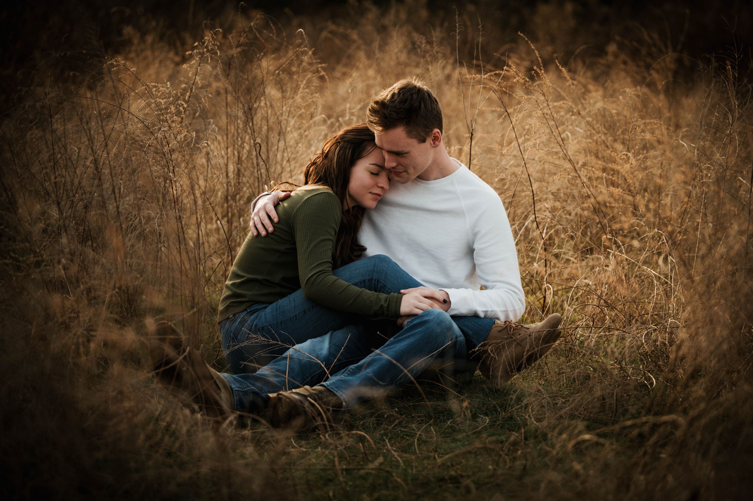 Intimate couples portrait session in tall autumn grass at sunset.