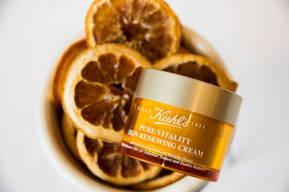 Kiehl's skincare cream product displayed with dried orange slices.