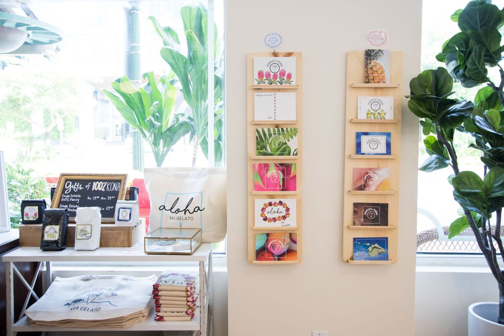 Bright home office workspace with colorful artwork display and green plants.