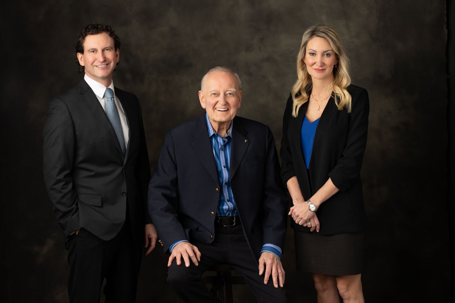 Professional group photo of business team against dark studio background.