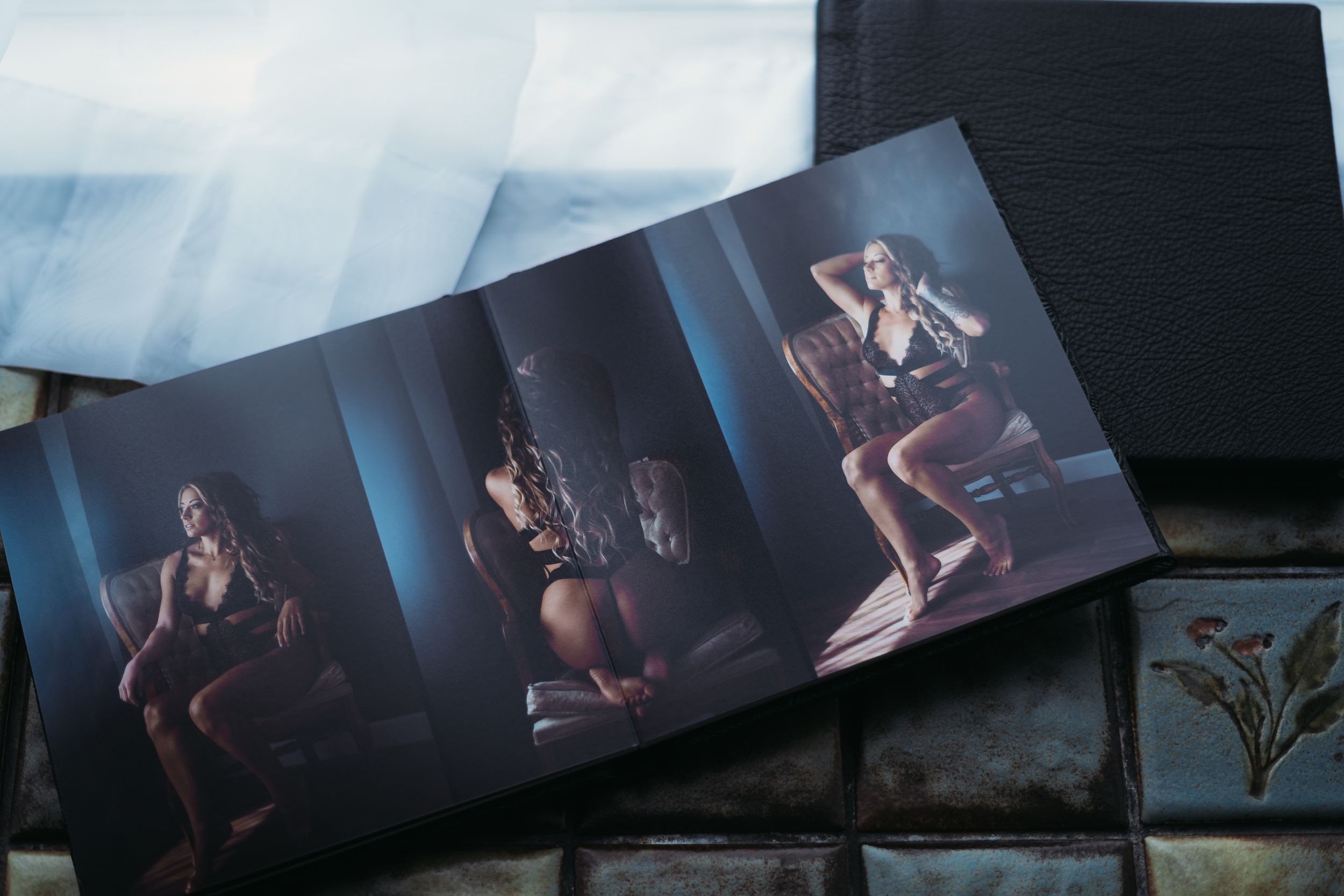 Artistic boudoir photo album displaying a series of moody portraits.
