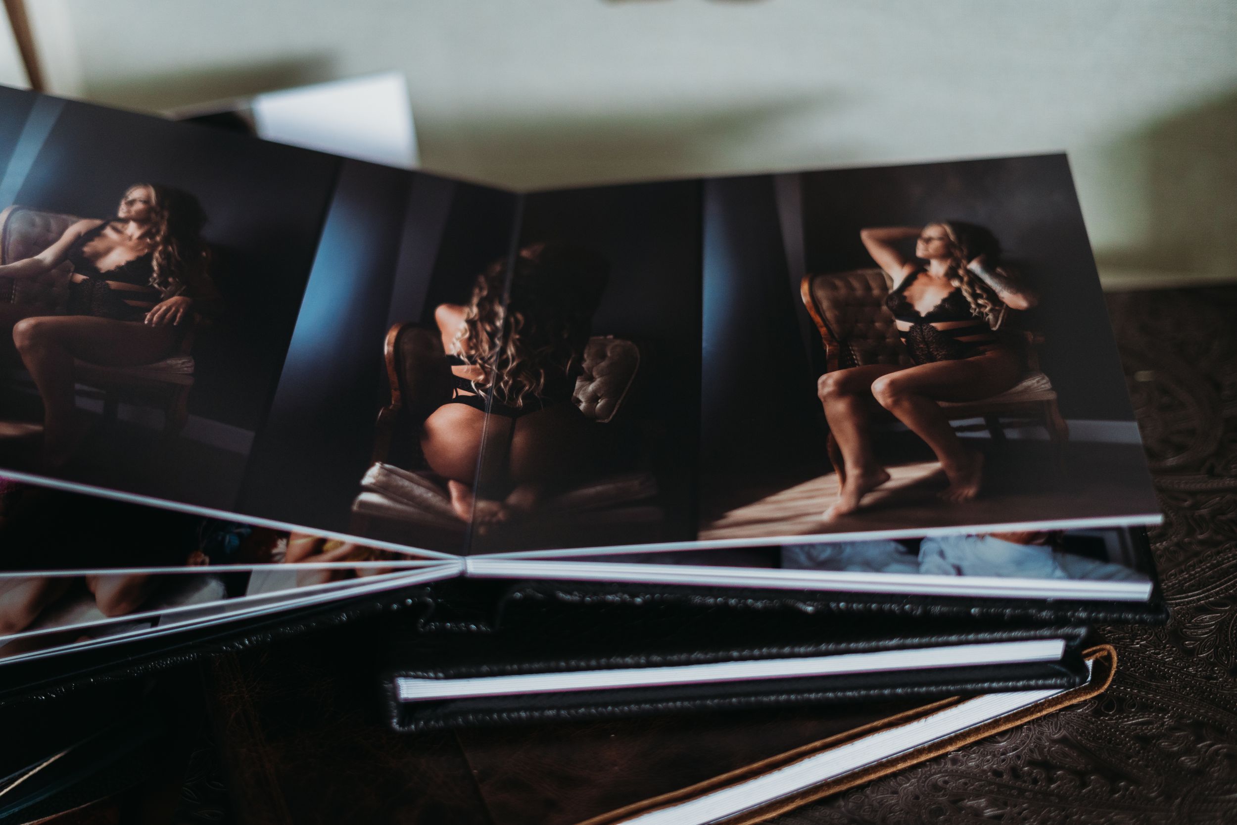 Professional photo album displaying artistic boudoir photography layouts.