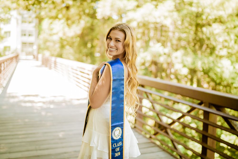 Joyful UC Santa Cruz Graduate in Graduation Portrait Smiling