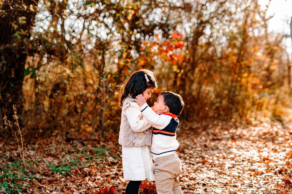 Indian siblings hugging child brother sister photographer at Coal Creek Farm Jenks Tulsa Oklahoma