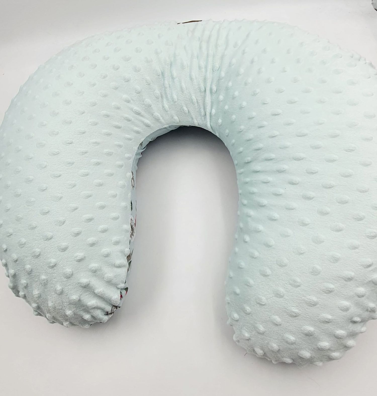 Soft minky textured nursing pillow in light mint green color.