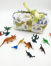 Safari-themed baby accessories featuring playful animal prints and green ribbon accents.