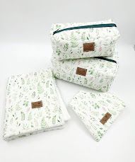 Delicate floral and botanical print baby accessories arranged on white background.