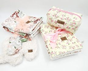 Floral print fabric cosmetic bags in pink and white patterns displayed at different angles.