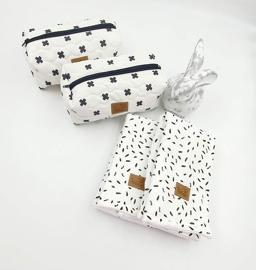 Black and white patterned toiletry bags and drawstring pouch with minimalist design.