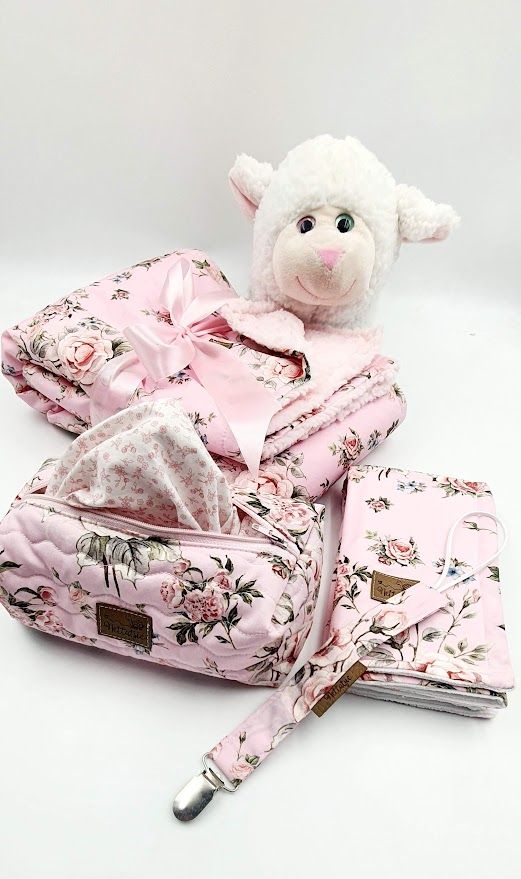 Floral print baby accessories set with plush lamb toy and pacifier clip.
