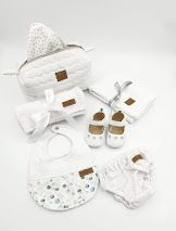 White baby accessories collection featuring diaper bags, shoes, and bibs with leather accents.