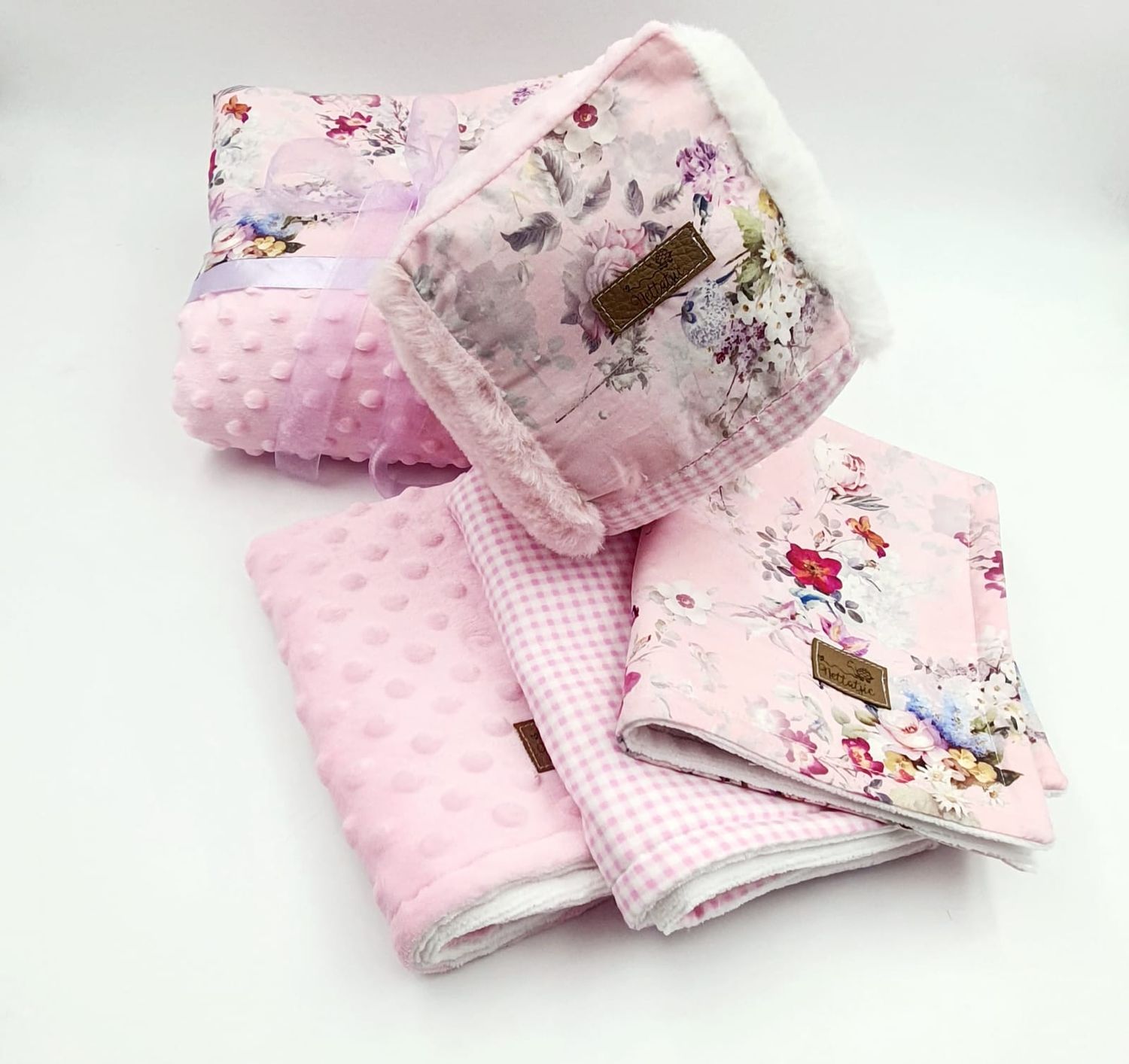 Pink minky baby blankets with floral patterns and soft textured fabric displayed in various angles.