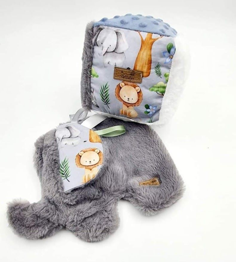 Gray plush nursing pillow with animal print design and soft furry texture.