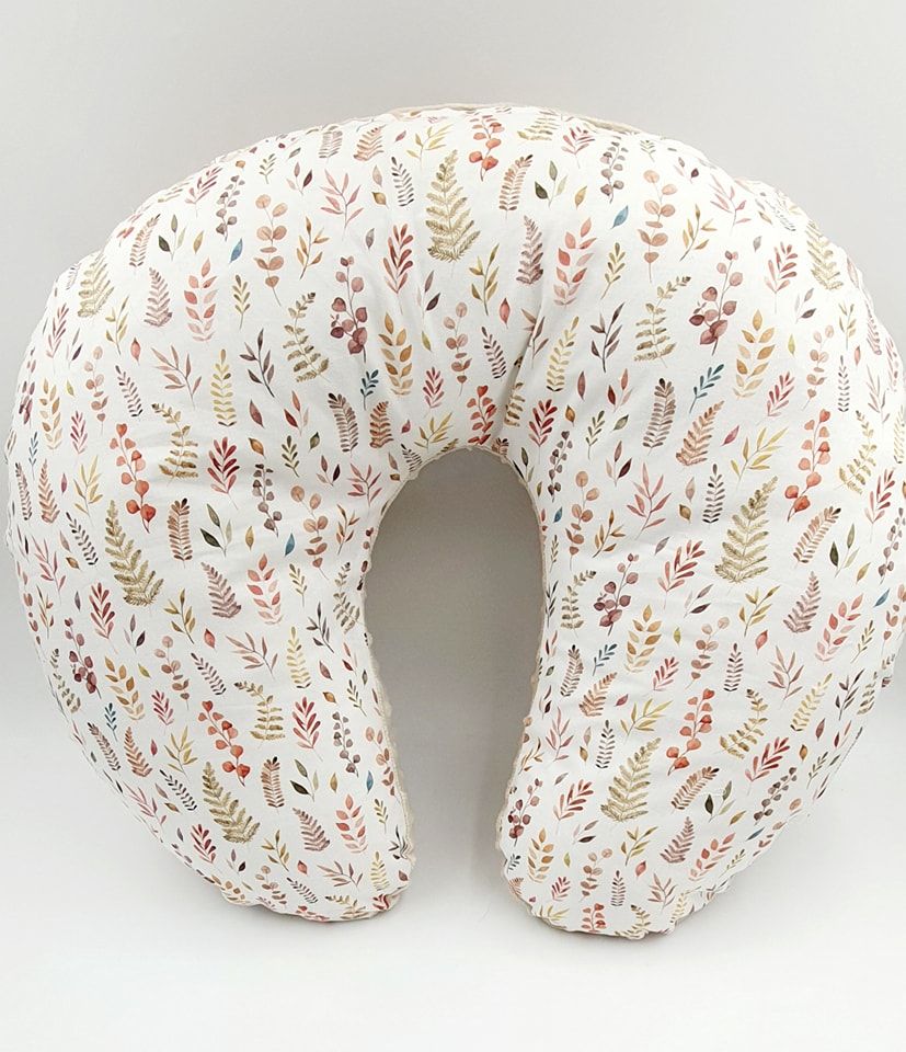 White nursing pillow with delicate pink and beige floral pattern shown from multiple angles.